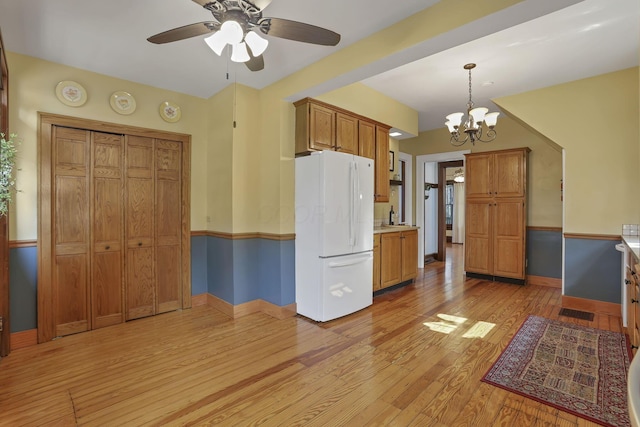 206 E Fair Ave, Lancaster, OH 43130 - kitchen featuring freestanding refrigerator, light wood-style flooring, ceiling fan, brown cabinetry, and light countertops