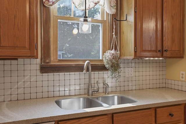 206 E Fair Ave, Lancaster, OH 43130 - kitchen with brown cabinets, backsplash, and light stone countertops