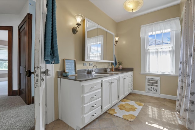 206 E Fair Ave, Lancaster, OH 43130 - bathroom featuring double vanity, heating unit, and tile patterned floors