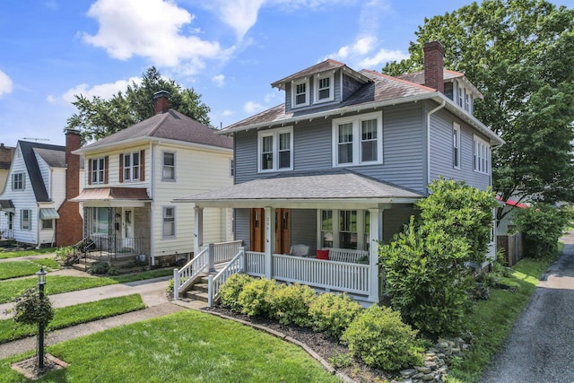 206 E Fair Ave, Lancaster, OH 43130 - american foursquare style home with covered porch, a front lawn, a chimney, and roof with shingles