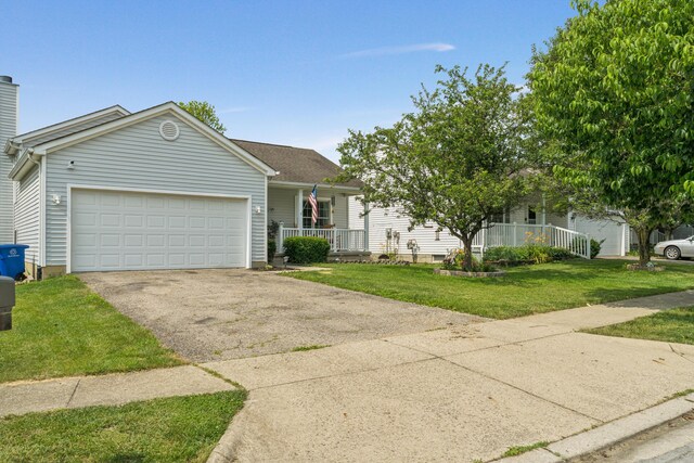 2587 Weeping Willow Ct, Columbus, OH 43207 - view of front of property with asphalt driveway, a porch, a garage, and a front lawn