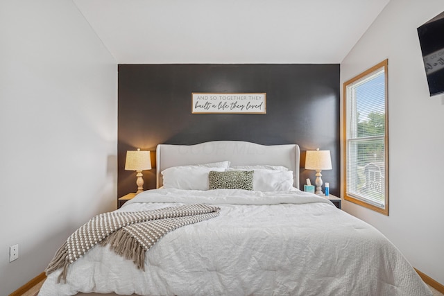 2587 Weeping Willow Ct, Columbus, OH 43207 - bedroom featuring carpet flooring, an accent wall, and vaulted ceiling