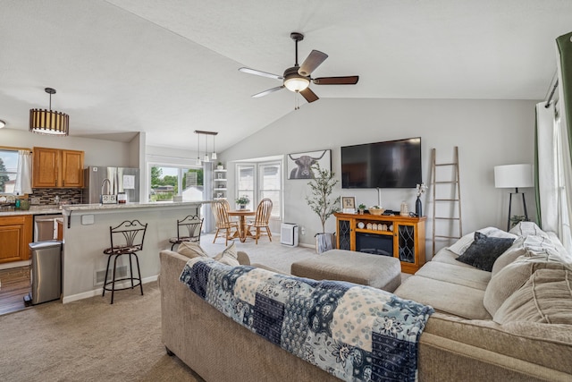 2587 Weeping Willow Ct, Columbus, OH 43207 - living room featuring light colored carpet, plenty of natural light, a ceiling fan, and vaulted ceiling