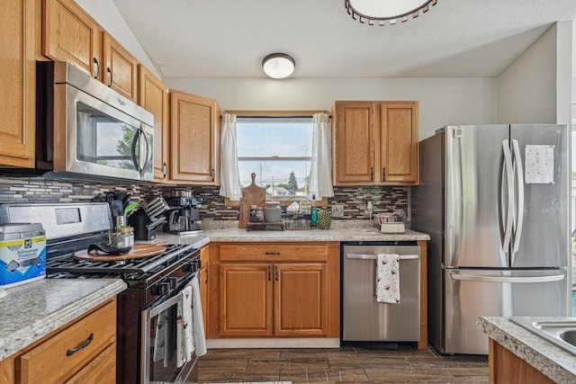 2587 Weeping Willow Ct, Columbus, OH 43207 - kitchen featuring appliances with stainless steel finishes, backsplash, light countertops, and dark wood-style floors