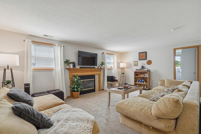 2587 Weeping Willow Ct, Columbus, OH 43207 - carpeted living room featuring a fireplace with flush hearth and a textured ceiling