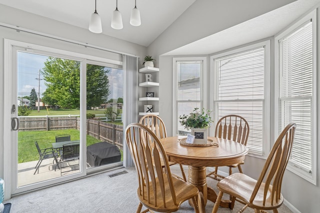 2587 Weeping Willow Ct, Columbus, OH 43207 - carpeted dining space with vaulted ceiling and baseboards