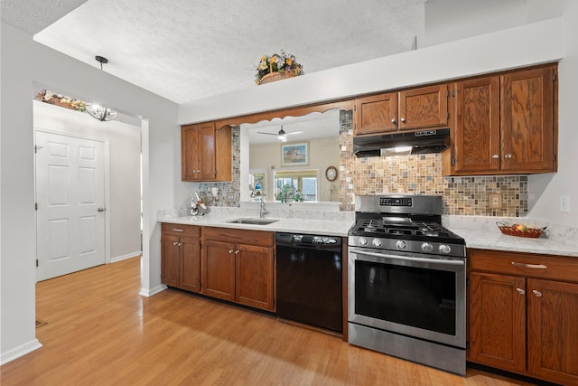 3625 Peany Ln, Canal Winchester, OH 43110 - kitchen featuring dishwasher, stainless steel range with gas stovetop, under cabinet range hood, light wood-style flooring, and decorative backsplash