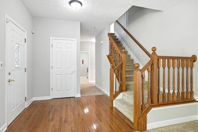 5497 Mirage Dr, Hilliard, OH 43026 - entrance foyer featuring hardwood / wood-style floors, stairway, and a textured ceiling