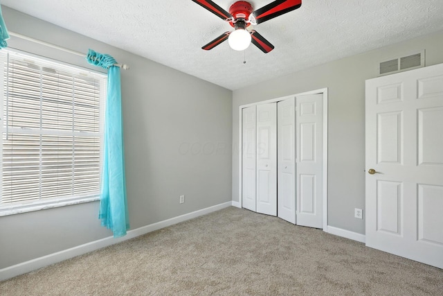 5497 Mirage Dr, Hilliard, OH 43026 - unfurnished bedroom with carpet flooring, a closet, a textured ceiling, and a ceiling fan
