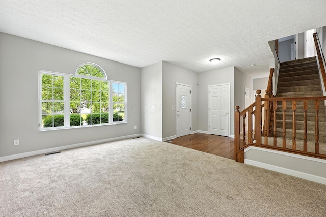 5497 Mirage Dr, Hilliard, OH 43026 - carpeted entrance foyer featuring stairs and a textured ceiling
