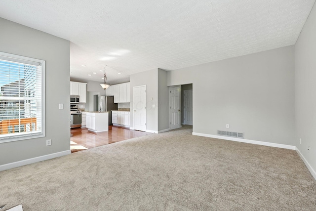 5497 Mirage Dr, Hilliard, OH 43026 - unfurnished living room featuring carpet and a textured ceiling