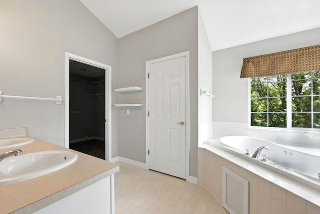 5497 Mirage Dr, Hilliard, OH 43026 - full bathroom with a bath, vaulted ceiling, double vanity, and a walk in closet