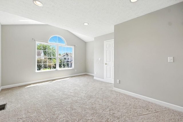 5497 Mirage Dr, Hilliard, OH 43026 - carpeted empty room with vaulted ceiling, recessed lighting, and a textured ceiling