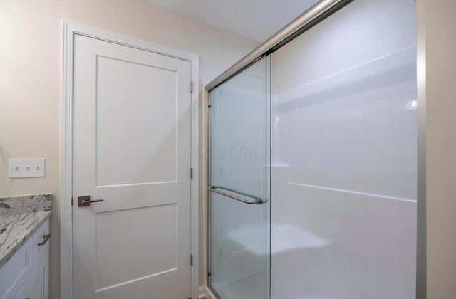 32 Maple St, Jeffersonville, OH 43128 - bathroom featuring a shower stall and vanity