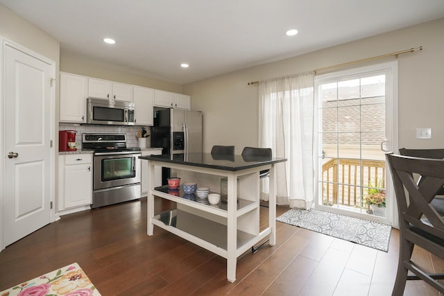 5649 Chippewa Falls St, Dublin, OH 43016 - kitchen featuring appliances with stainless steel finishes, open shelves, white cabinetry, dark wood finished floors, and recessed lighting