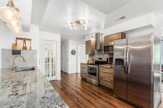 230 Barcelona Ave, Westerville, OH 43081 - kitchen with appliances with stainless steel finishes, dark wood-style floors, tasteful backsplash, wall chimney exhaust hood, and light stone countertops