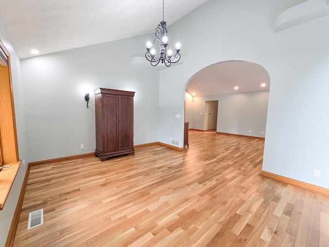 3100 Kropp Rd, Grove City, OH 43123 - empty room featuring arched walkways, light wood finished floors, a chandelier, high vaulted ceiling, and recessed lighting