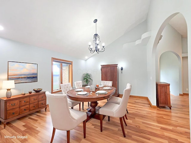 3100 Kropp Rd, Grove City, OH 43123 - dining space with arched walkways, light wood-style flooring, high vaulted ceiling, and a chandelier