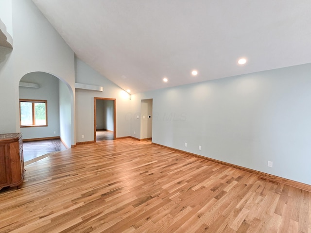 3100 Kropp Rd, Grove City, OH 43123 - spare room with light wood finished floors, arched walkways, recessed lighting, high vaulted ceiling, and a wall unit AC