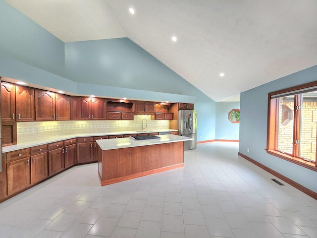 3100 Kropp Rd, Grove City, OH 43123 - kitchen with stainless steel fridge with ice dispenser, high vaulted ceiling, light countertops, a kitchen island, and tasteful backsplash