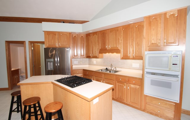 3100 Kropp Rd, Grove City, OH 43123 - kitchen featuring stainless steel appliances, light flooring, vaulted ceiling, a kitchen island, and light countertops
