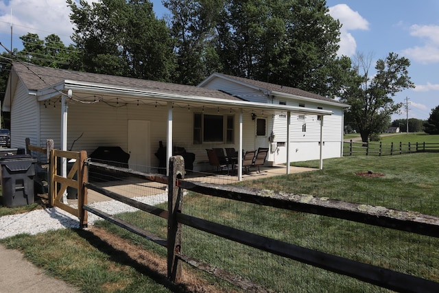 4224 Tschopp Rd NE, Lancaster, OH 43130 - view of front of house featuring a patio, roof with shingles, and a carport