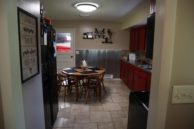 4224 Tschopp Rd NE, Lancaster, OH 43130 - kitchen featuring black range with electric stovetop, a baseboard heating unit, dark countertops, tasteful backsplash, and light tile patterned flooring