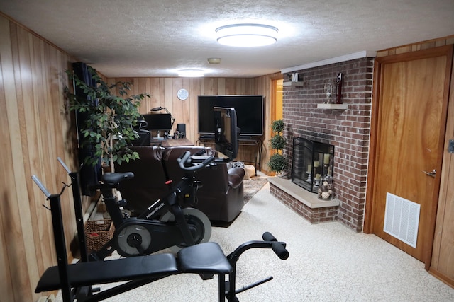 4224 Tschopp Rd NE, Lancaster, OH 43130 - exercise room with wooden walls, carpet floors, a textured ceiling, and a fireplace