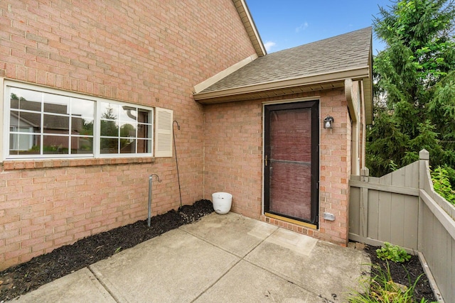5724 Sanderling Ln, Westerville, OH 43081 - view of exterior entry featuring roof with shingles and a patio area