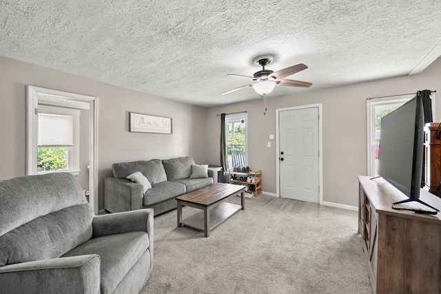 3053 E Old Duvall Ct, Lockbourne, OH 43137 - living room featuring a ceiling fan, light colored carpet, and a textured ceiling