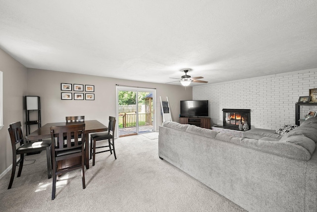 3053 E Old Duvall Ct, Lockbourne, OH 43137 - living area featuring ceiling fan, light colored carpet, a brick fireplace, and a textured ceiling