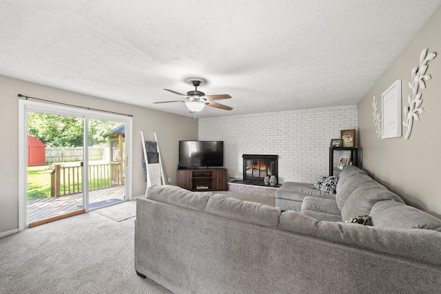 3053 E Old Duvall Ct, Lockbourne, OH 43137 - living area with a textured ceiling, ceiling fan, carpet, and a fireplace