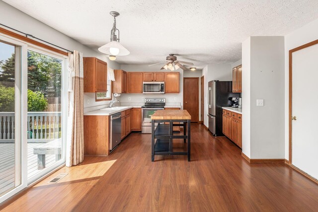 217 Knight Dream St, Delaware, OH 43015 - kitchen with appliances with stainless steel finishes, light countertops, dark wood-style flooring, ceiling fan, and a textured ceiling