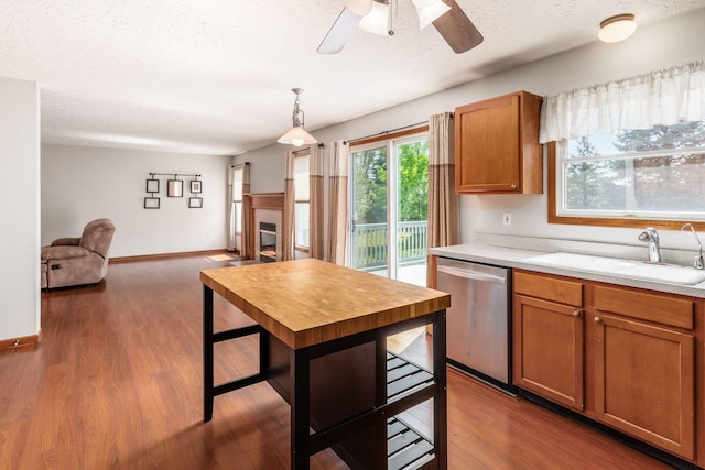 217 Knight Dream St, Delaware, OH 43015 - kitchen featuring dishwasher, light countertops, open floor plan, a textured ceiling, and brown cabinets
