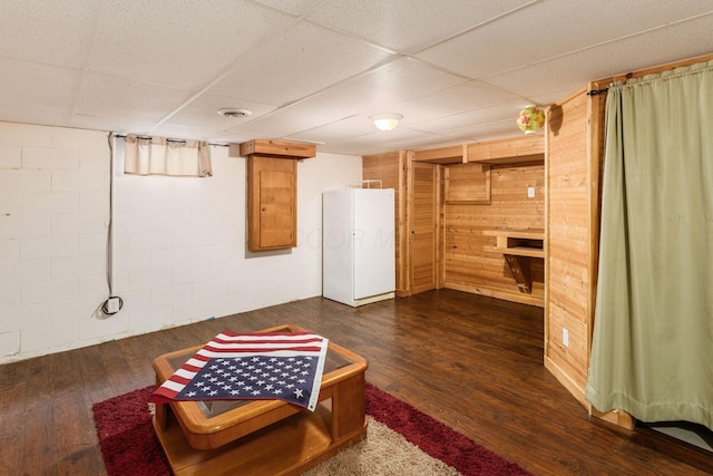 217 Knight Dream St, Delaware, OH 43015 - finished below grade area featuring wooden walls, dark wood-style floors, a drop ceiling, and concrete block wall