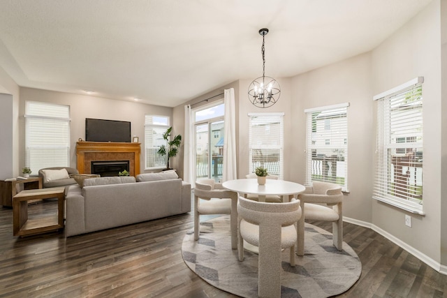 978 Vanwert Loop, Blacklick, OH 43004 - dining space featuring dark wood-type flooring, a fireplace, and a chandelier