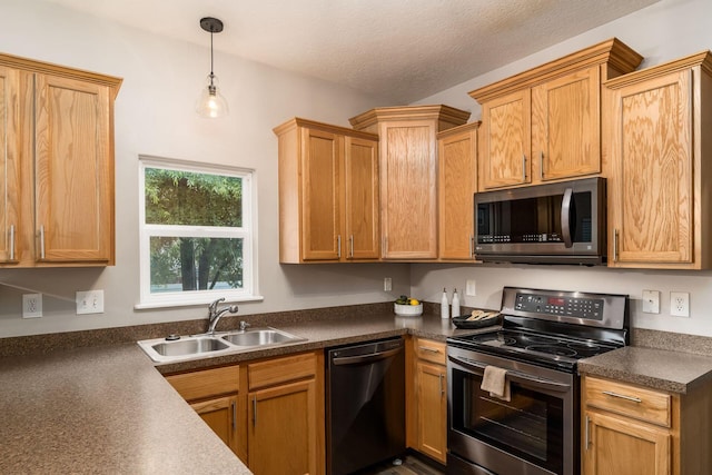 978 Vanwert Loop, Blacklick, OH 43004 - kitchen featuring appliances with stainless steel finishes, dark countertops, hanging light fixtures, and a textured ceiling