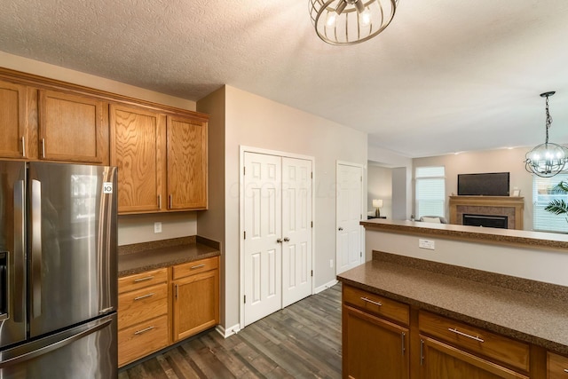978 Vanwert Loop, Blacklick, OH 43004 - kitchen with freestanding refrigerator, dark countertops, a chandelier, and dark wood-type flooring