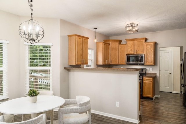 978 Vanwert Loop, Blacklick, OH 43004 - kitchen featuring stainless steel microwave, a chandelier, dark wood-style floors, decorative light fixtures, and freestanding refrigerator