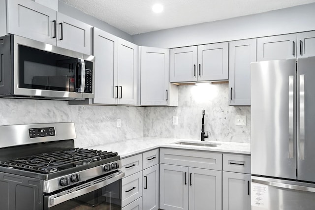 4120 Mcallister Ave, Columbus, OH 43227 - kitchen featuring appliances with stainless steel finishes, light stone countertops, decorative backsplash, and a textured ceiling