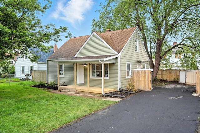 4120 Mcallister Ave, Columbus, OH 43227 - view of front facade with covered porch, roof with shingles, and a chimney