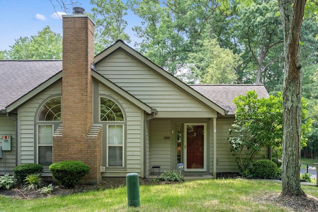 354 Hidden Ravines Dr, Powell, OH 43065 - view of front facade featuring a shingled roof, a chimney, and a front yard