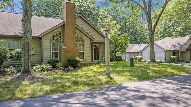 354 Hidden Ravines Dr, Powell, OH 43065 - view of front of home with a front lawn and a chimney