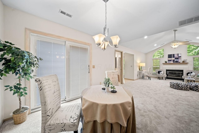 354 Hidden Ravines Dr, Powell, OH 43065 - dining space featuring light carpet, lofted ceiling, a chandelier, a fireplace, and ceiling fan