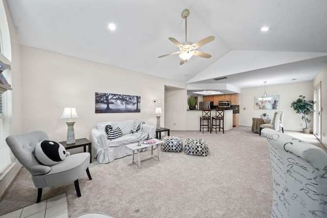 354 Hidden Ravines Dr, Powell, OH 43065 - living room featuring vaulted ceiling, light carpet, a ceiling fan, and a chandelier