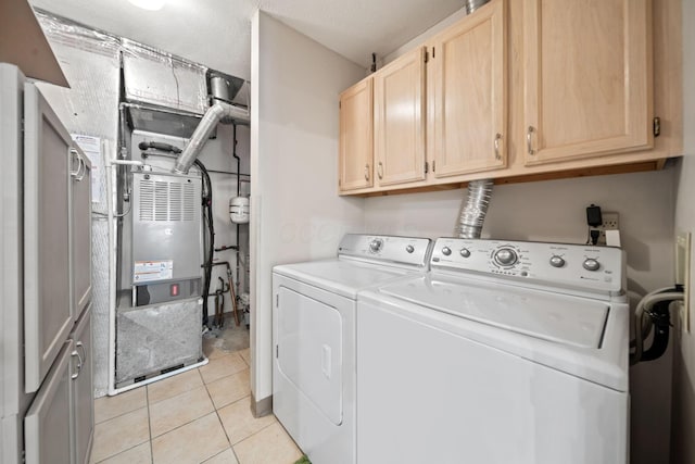 354 Hidden Ravines Dr, Powell, OH 43065 - washroom featuring washer and dryer, cabinet space, light tile patterned flooring, and heating unit