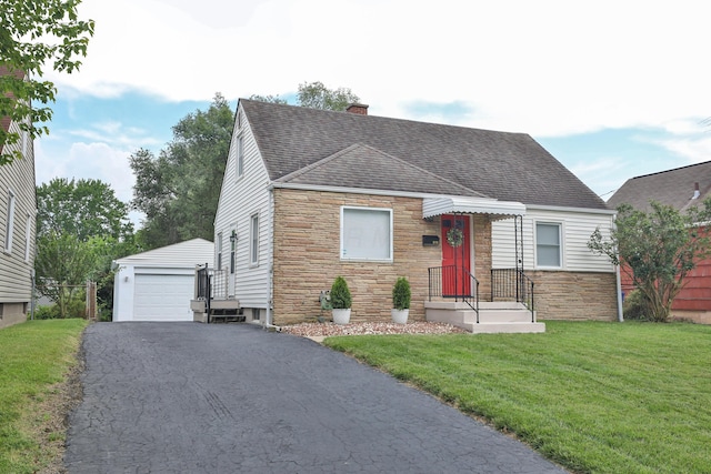 815 Eddystone Ave, Columbus, OH 43224 - new england style home with roof with shingles, stone siding, an outdoor structure, and a garage