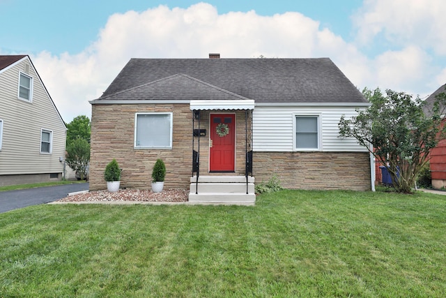815 Eddystone Ave, Columbus, OH 43224 - view of front of home with stone siding, a shingled roof, and a front yard
