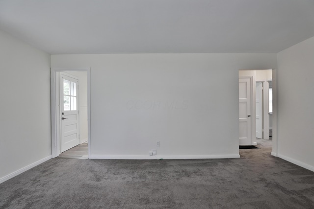 815 Eddystone Ave, Columbus, OH 43224 - empty room featuring dark colored carpet and baseboards