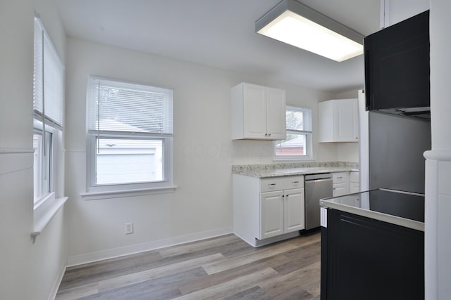 815 Eddystone Ave, Columbus, OH 43224 - kitchen with stainless steel dishwasher, white cabinetry, light countertops, and light wood-style flooring